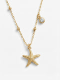 Nova Pendant Necklace — gold satellite chain with textured sculptural pendant and offset bezel-set crystal charm