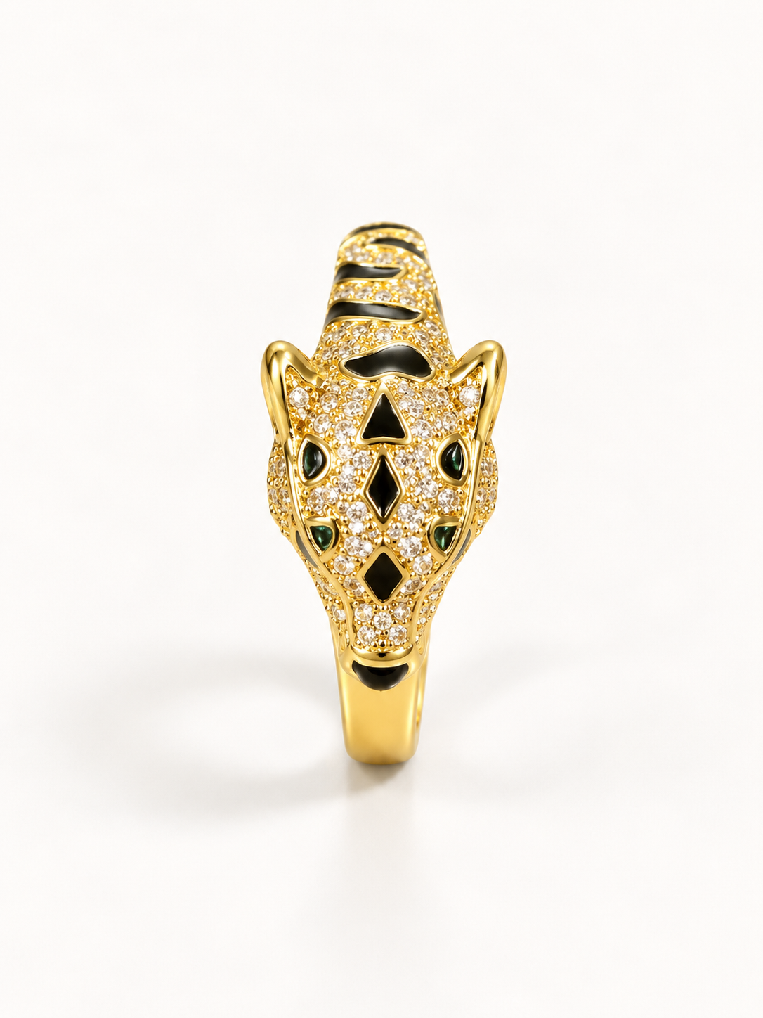 Gold-tone panther statement ring with black detailing, angled view