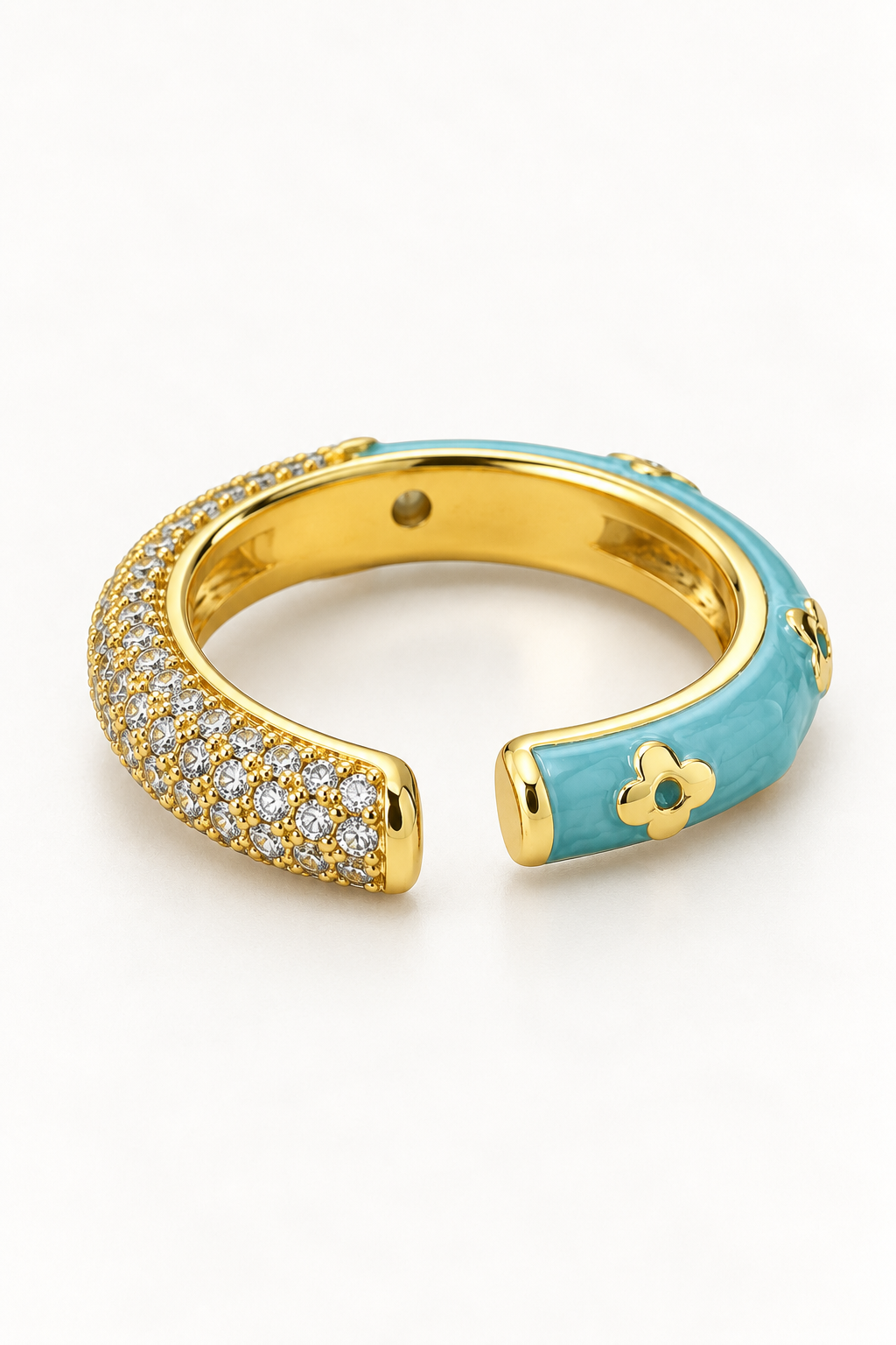 Angled view of marbled blue and gold-tone floral open ring with clear accents